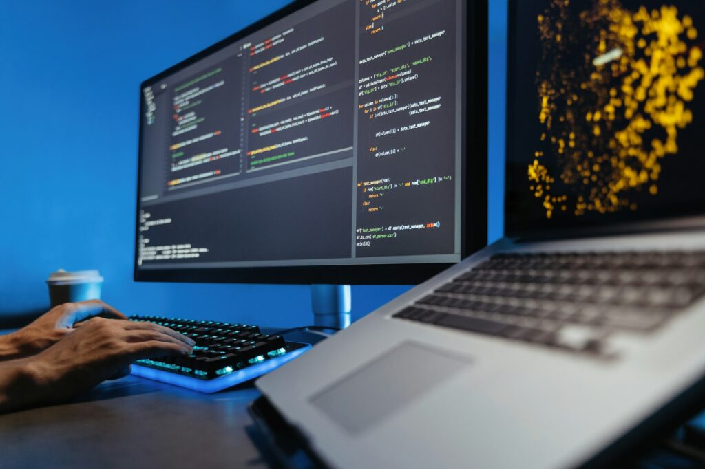 No face image of male hands typing on keyboard, writing html code for website on pc
